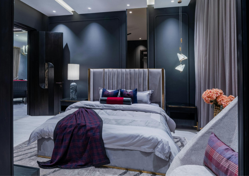 modern bedroom, bed, blanket, pillows, white lamp, flower pots-residential interior designers in hyderabad